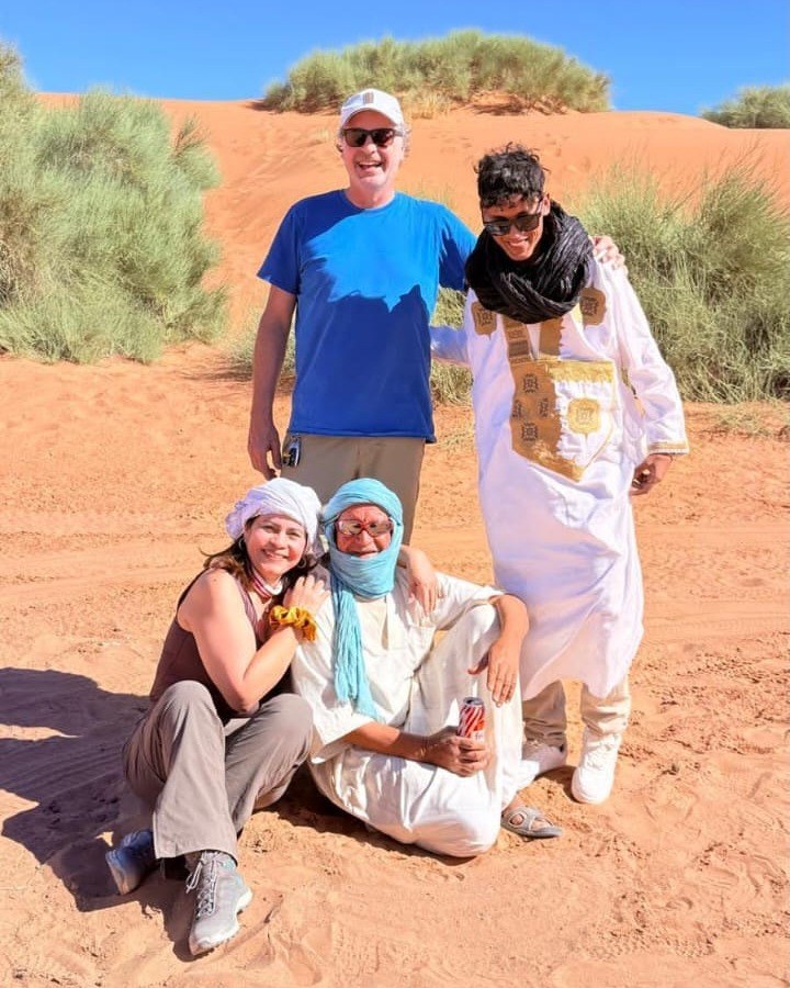 Ayoub Ibrahimi, co-founder of Morocco Private Escape, with travelers in the Sahara desert